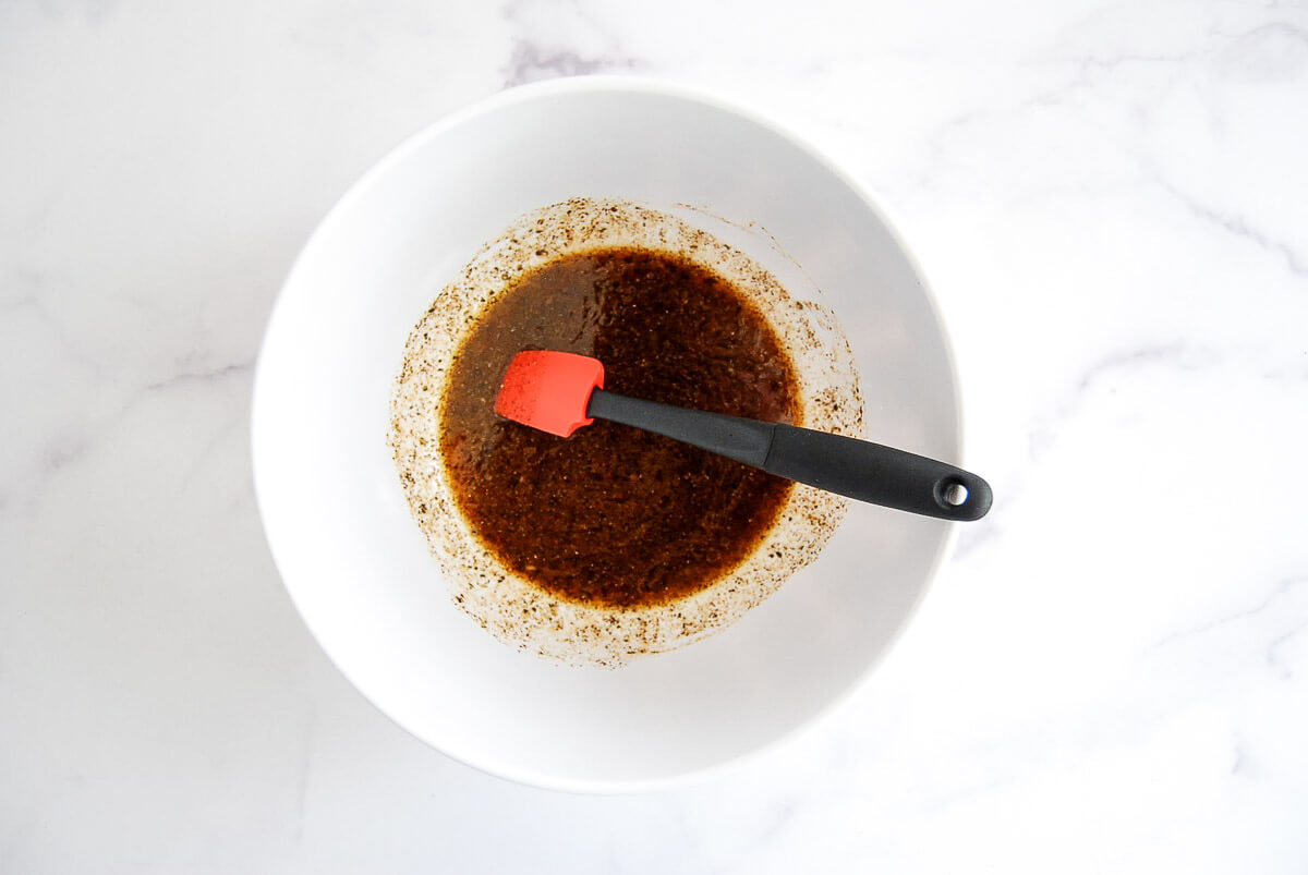 A bowl with a mixed skirt steak marinade.